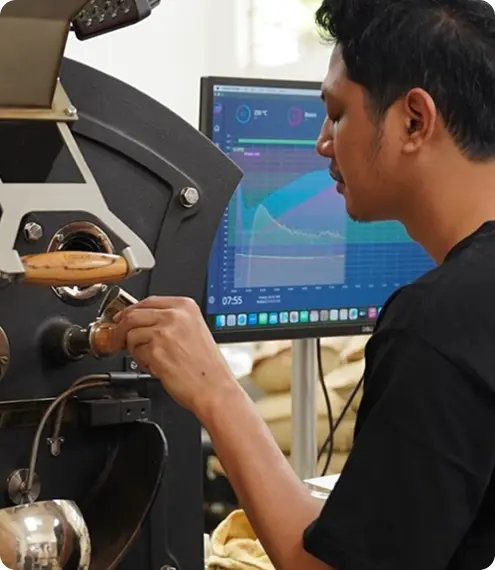 Roaster monitoring coffee roasting profile on screen